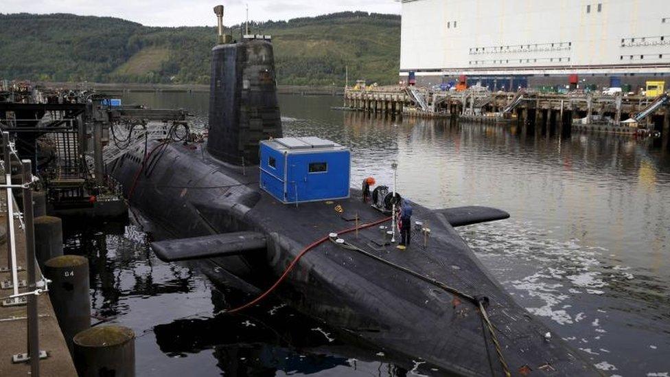 A nuclear submarine is seen at the Royal Navy"s submarine base at Faslane, Scotland,