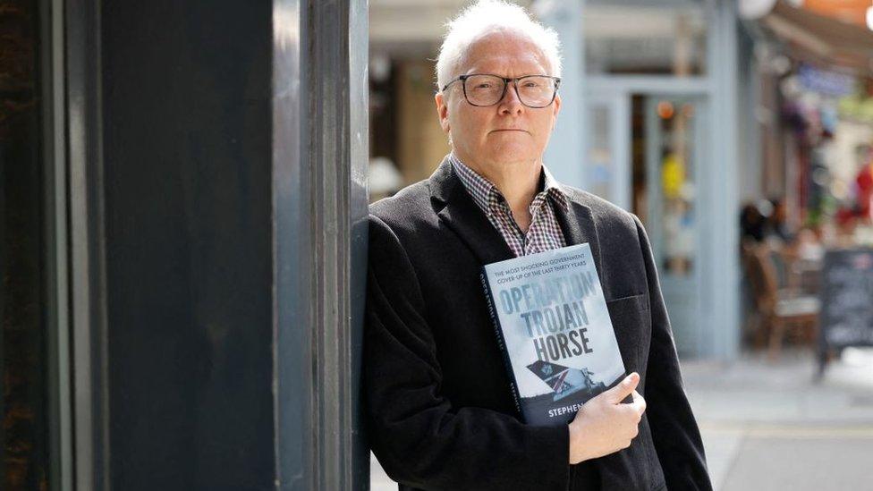 Journalist and author Stephen Davis poses with his new book Operation Trojan Horse