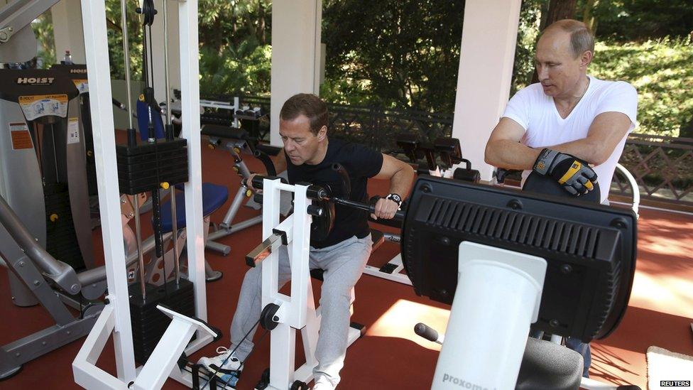 Russian President Vladimir Putin (R) and Prime Minister Dmitry Medvedev exercise in a gym at the Bocharov Ruchei state residence in Sochi, Russia, August 30, 2015.