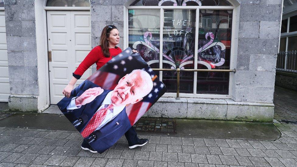 Woman carries Joe Biden poster