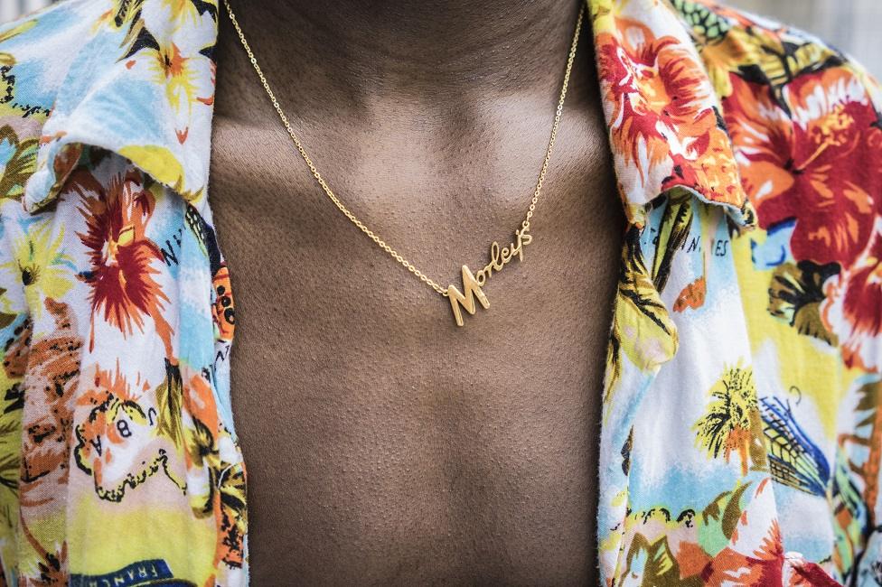 A man from Peckham wearing a colourful shirt and gold chain