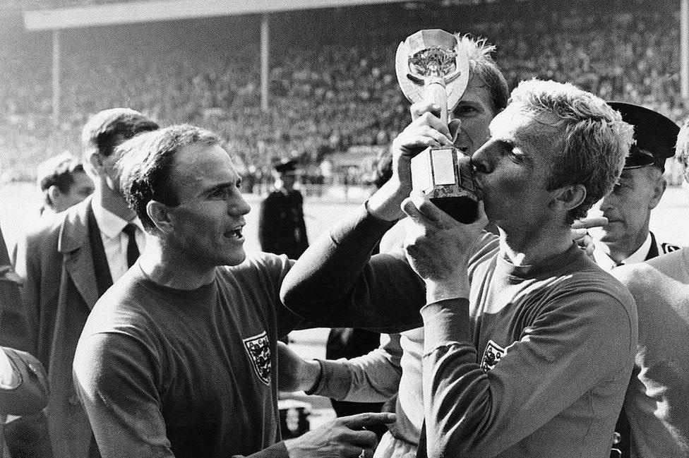 Bobby Moore kisses the World Cup trophy on the pitch at Wembley