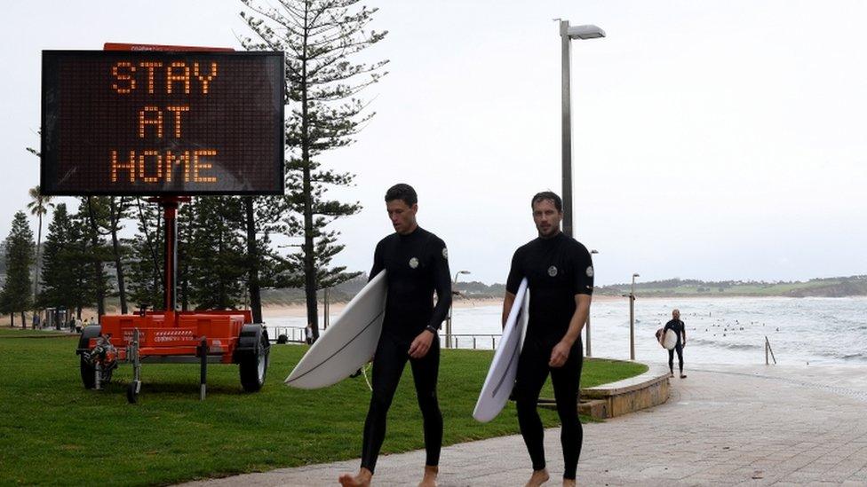 Public health messaging is displayed on temporary signage at Dee Why in Sydney, Australia