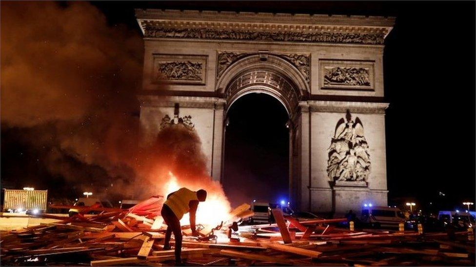 A a burning barricade during a yellow vest on the Champs-Élysées, 24 November