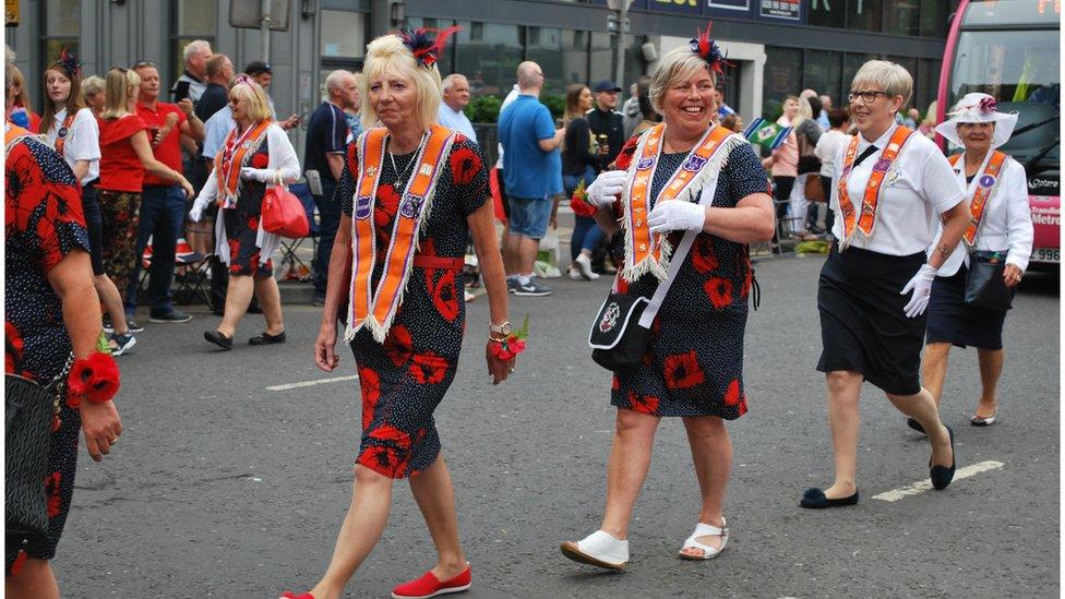 Women from the Orange Order take part in the parade in Belfast