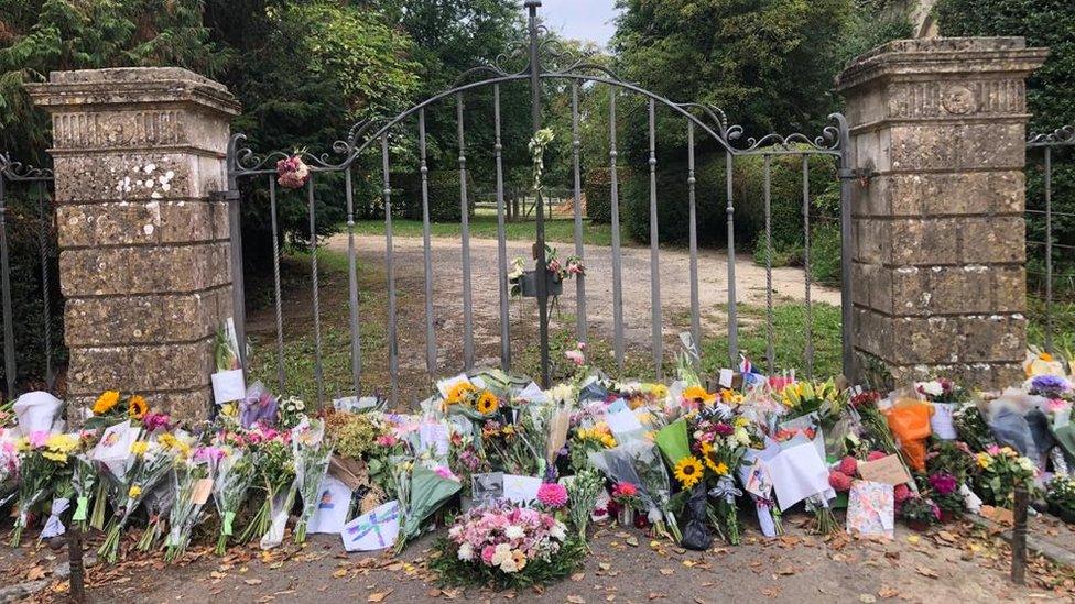 Flowers left outside the gate of Highgrove House in Tetbury