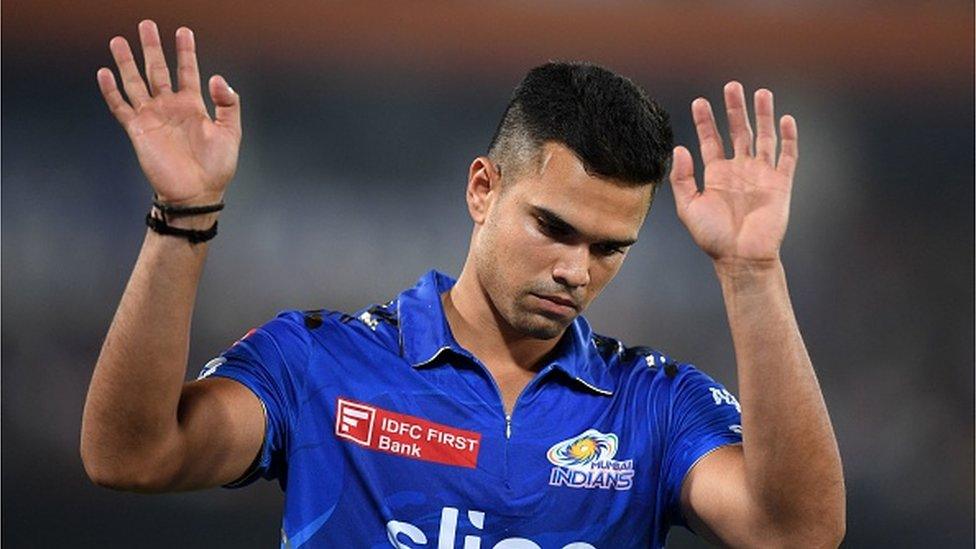 Mumbai Indians' Arjun Tendulkar gestures towards the spectators during the Indian Premier League (IPL) Twenty20 cricket match between Sunrisers Hyderabad and Mumbai Indians at the Rajiv Gandhi International Cricket Stadium in Hyderabad on April 18, 2023