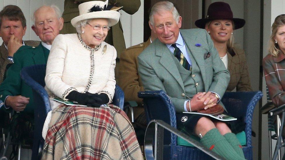 Queen Elizabeth II and Prince Charles, Prince of Wales watch the action during the Braemar Highland Games