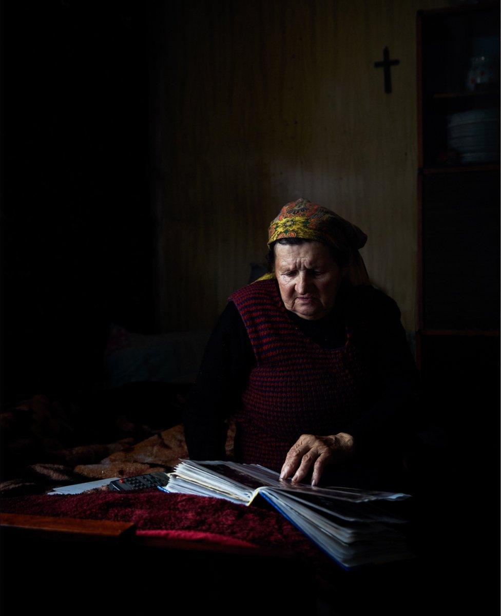 Woman looking at old photographs
