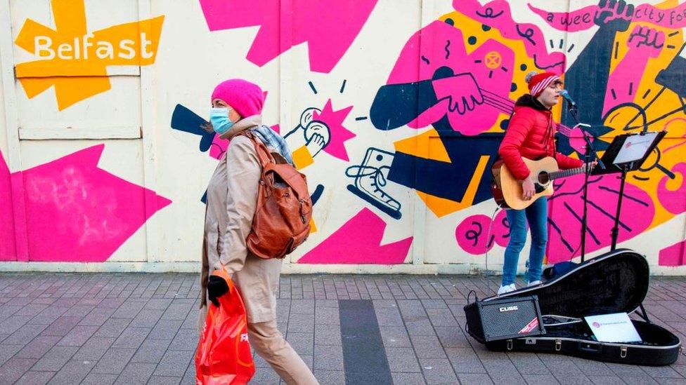 A man busking in Belfast in December 2020
