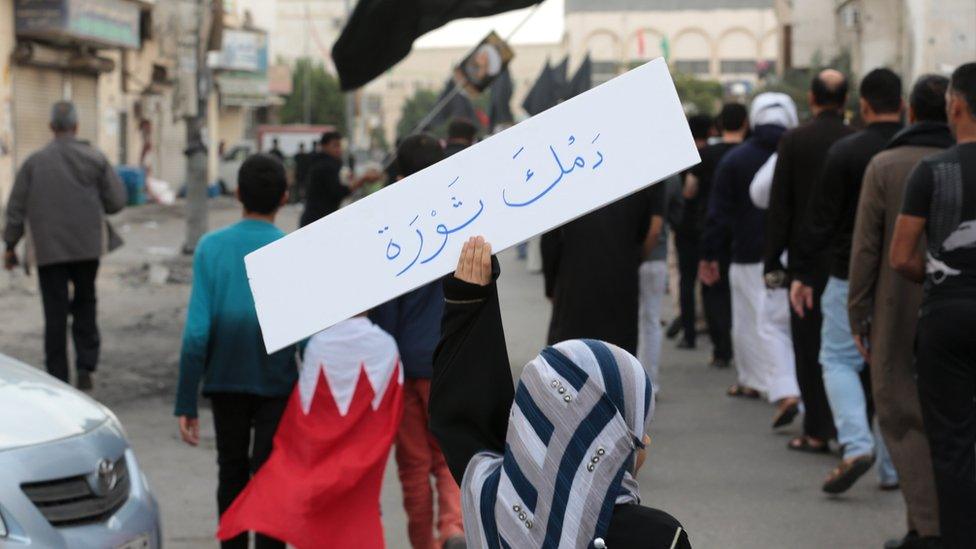 A Saudi Shia woman holds a placard saying "Your blood is a revolution", during a protest in the eastern coastal city of Qatif against the execution of the cleric Nimr al-Nimr (8 January 2016)