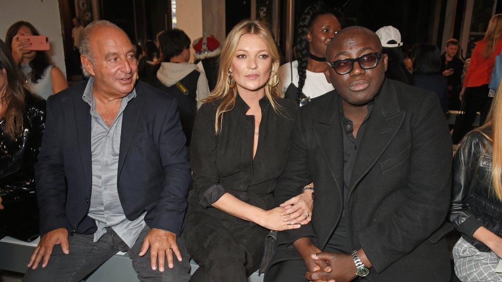 Arcadia Group chairman Sir Philip Green, Kate Moss and Edward Enninful sit by the catwalk.