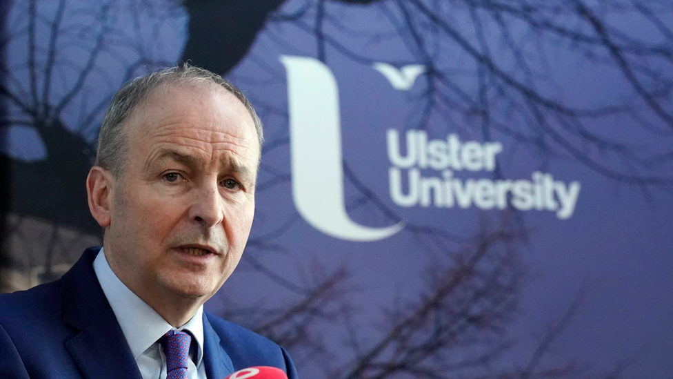 Micheál Martin with Ulster University logo in background