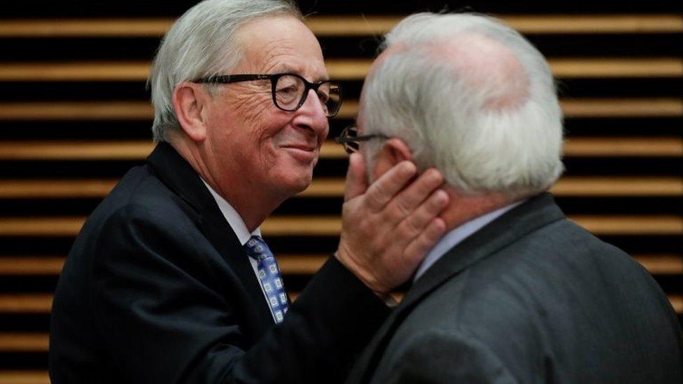 Jean-Claude Juncker playfully slaps fellow EU Commissioner Miguel Arias Canete at a Commission meeting in October, 2019