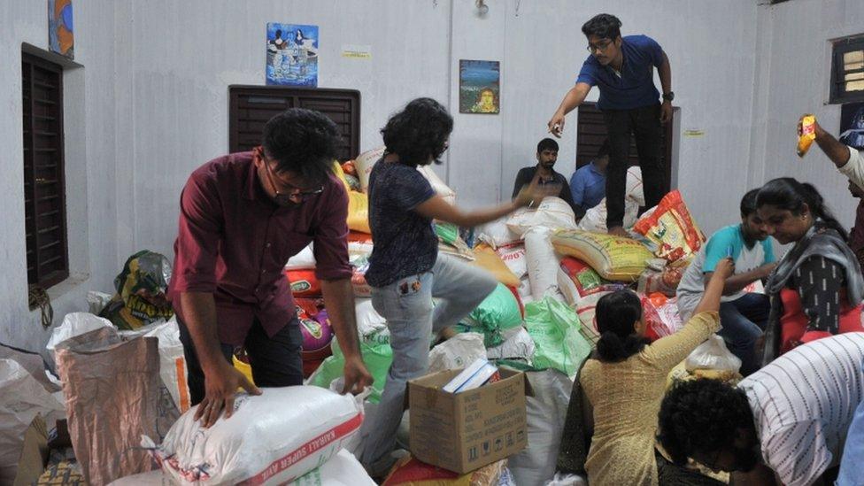 Volunteers handle and organise flood relief supplies