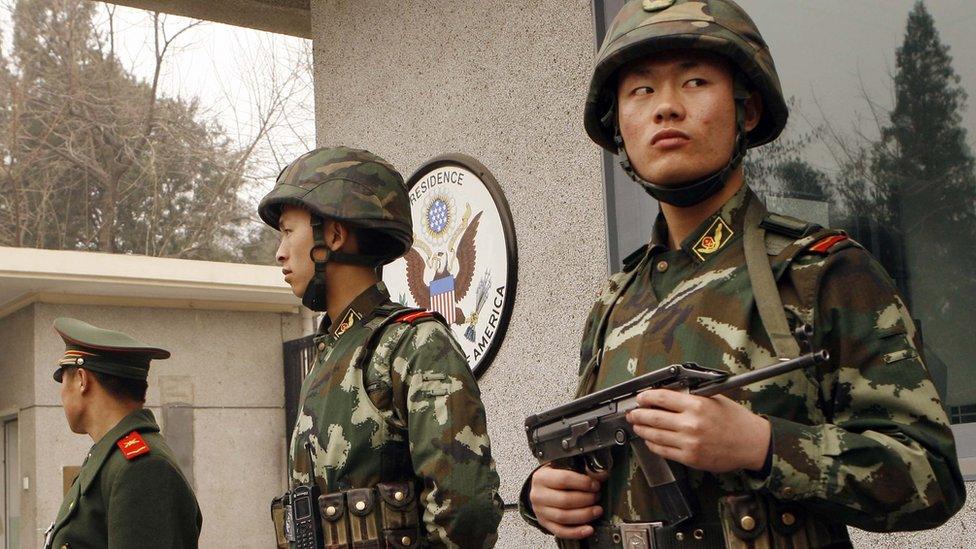 Three armed Chinese policemen guarding the US embassy in Beijing