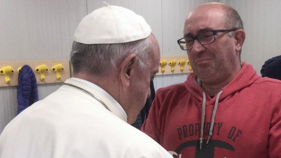 Pope Francis shakes hands with a local man during a visit in Amatrice, Italy 4 October 2016