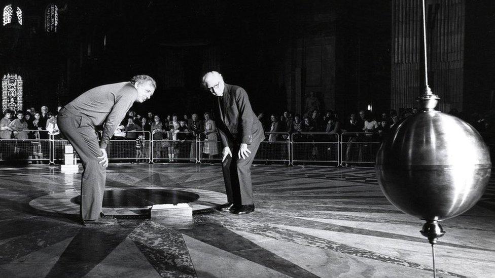 The Open University and BBC reconstruct the famous Foucault experiment, which proved the earth goes around the sun, by hanging a brass ball 300ft from the roof of St Paul’s Cathedral in London.