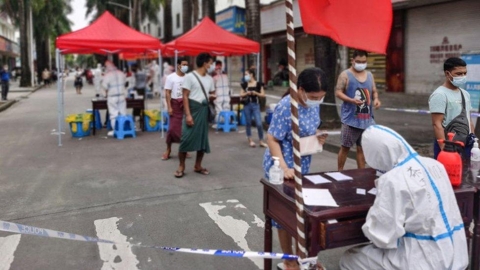 People queue to undergo nucleic acid testing for the Covid-19 coronavirus in the city of Ruili which borders Myanmar, in China's southwestern Yunnan province on July 5, 2021.