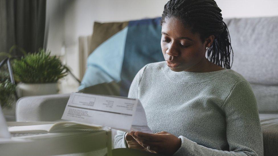 Woman looking at energy bill