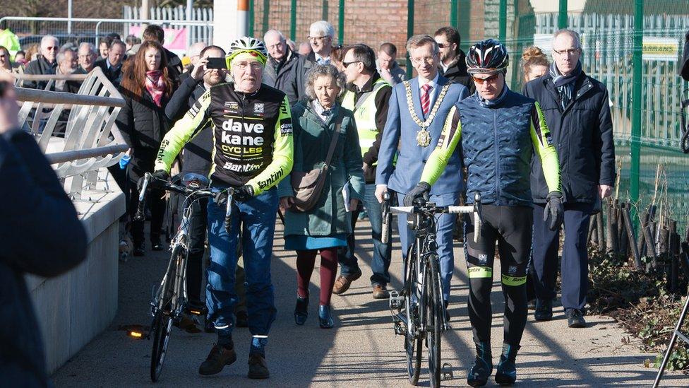 The actor's widow and the lord mayor led the crowd across the bridge