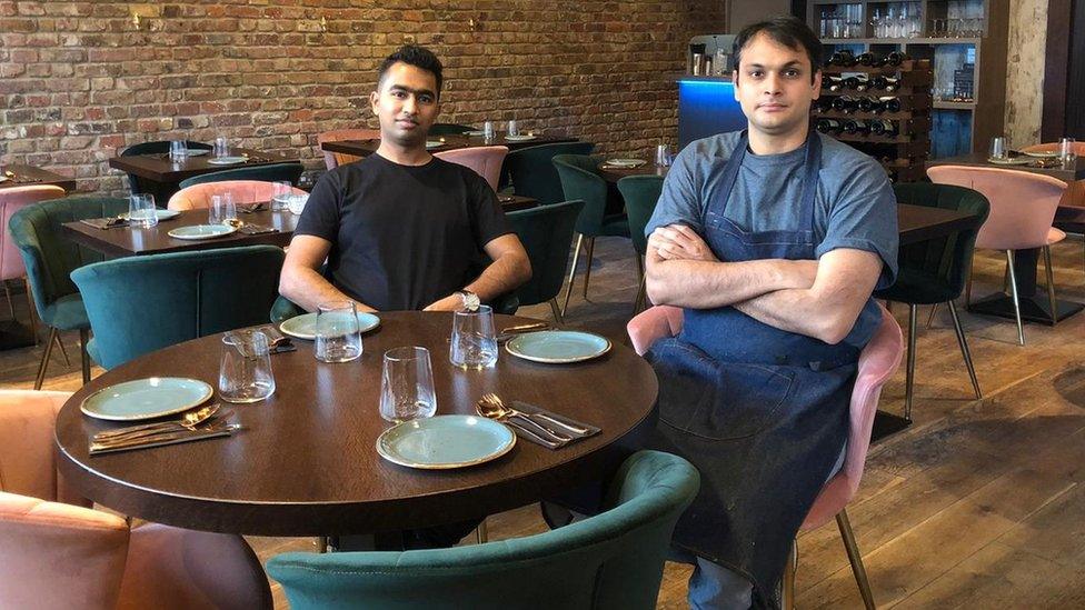 Kuldeep Mattegunta and his business partner seated at their restaurant