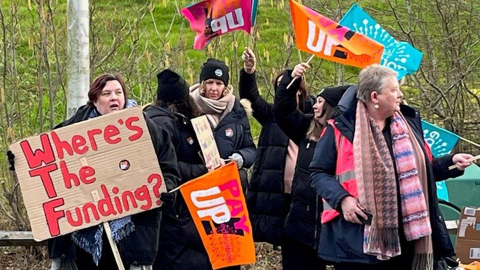 Teachers on strike holding up placards outside Ysgol y Deri school in Penarth