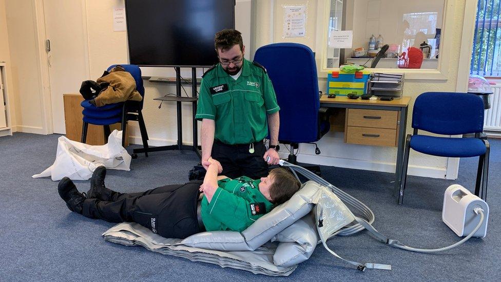 Ben Morris and Janice John training on a Mangar "Camel" Lifting device which can help patients that have fallen on the floor