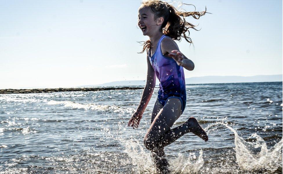 Girl splashing in seawater