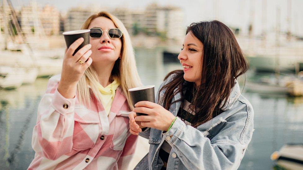 Two women comparing coffee