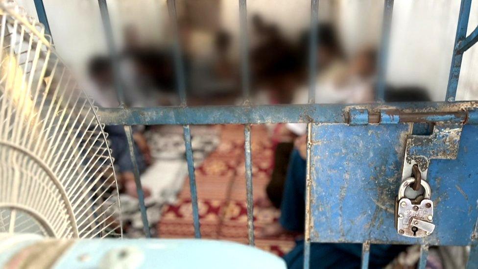 Blurred image of people in a cell