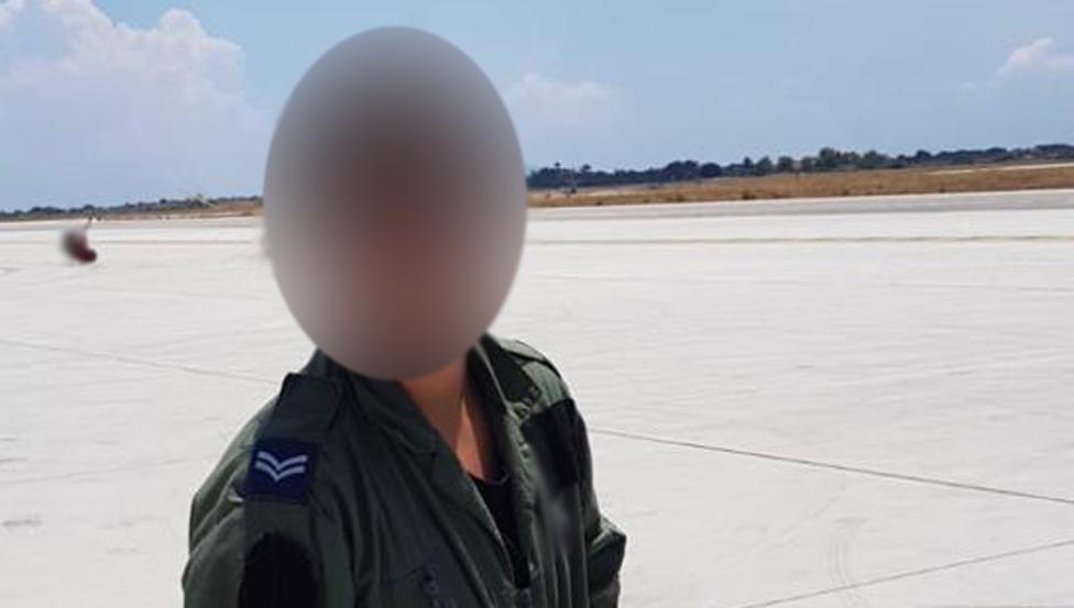 Sam, her face blurred, in uniform