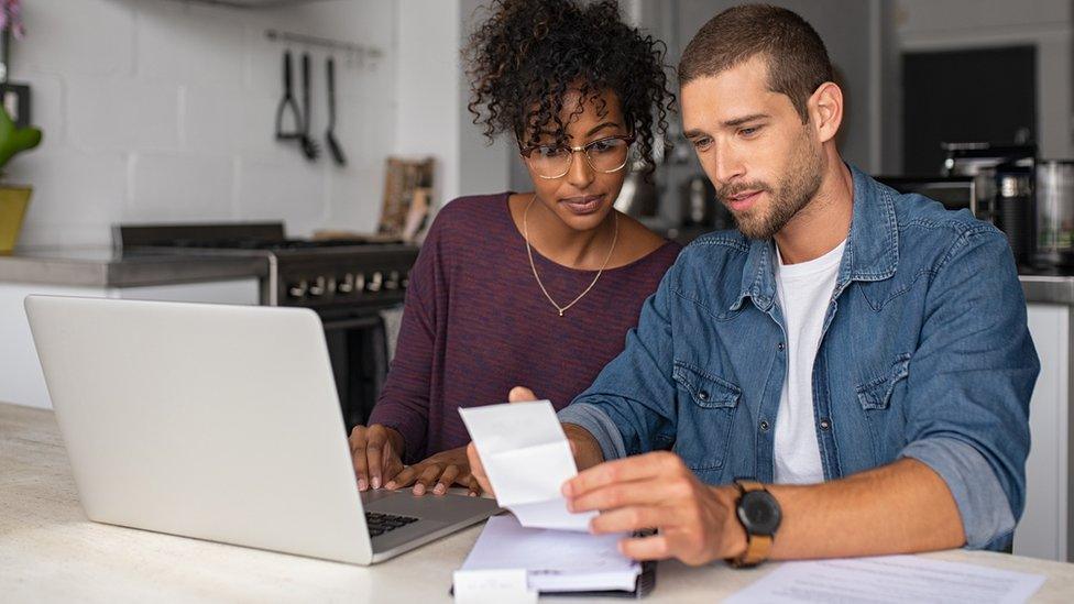 A couple looking at bills