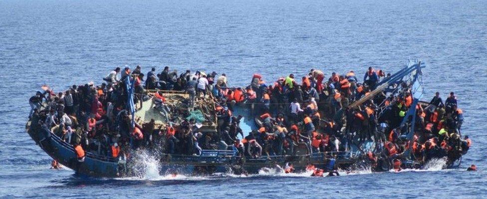 Migrants cling to a capsizing boat in the Mediterranean, 25 May