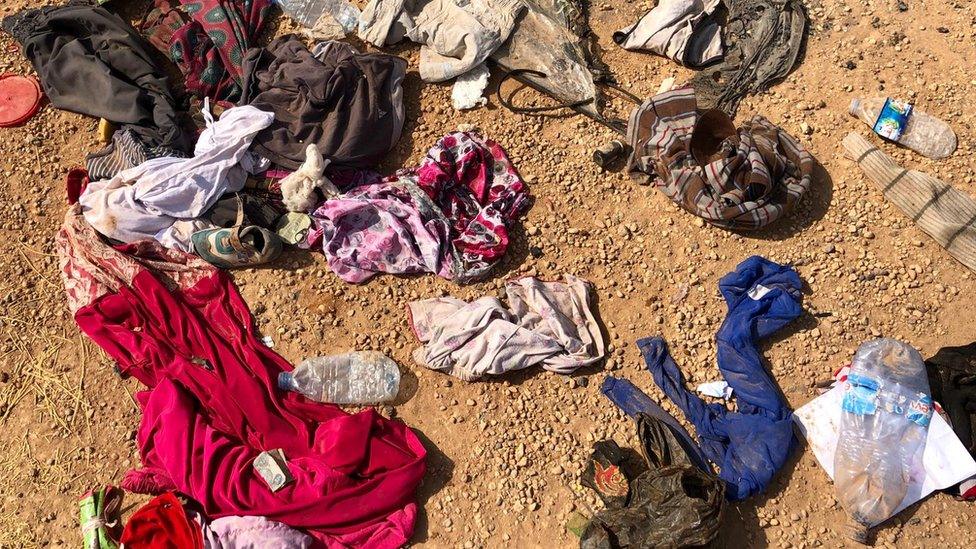 Belongings strewn across desert floor