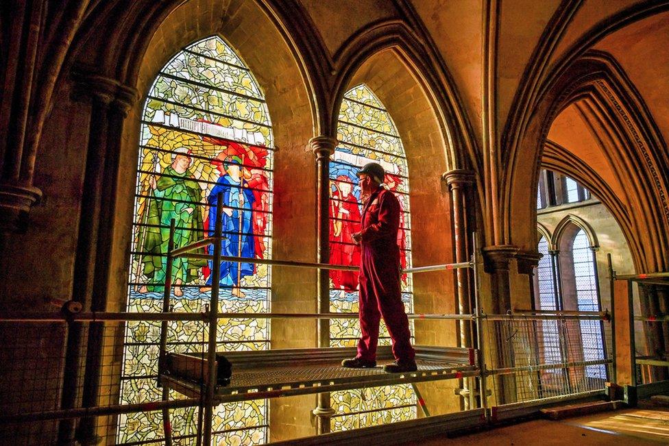 Head glass conservator Sam Kelly inspects the Angeli Laudantes and Angeli Ministrantes stained glass windows at Salisbury Cathedral as restoration gets under way.