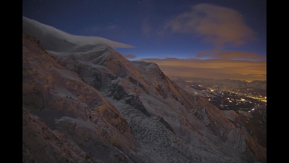 Light pollution reflected off the southern flanks of Western Europe's highest peak, Mont Blanc, under a full moon