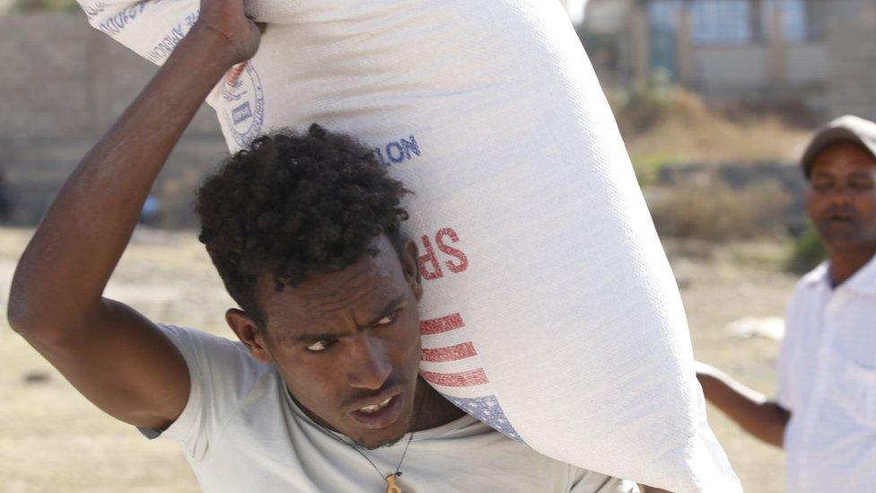 Tigray people, fled due to conflicts and taking shelter in Mekelle city of the Tigray region, in northern Ethiopia, receive the food aid distributed by United States Agency for International Development (USAID) on March 8, 2021.