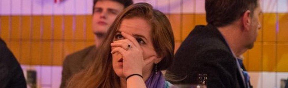 A woman reacts to the vote on election night in London