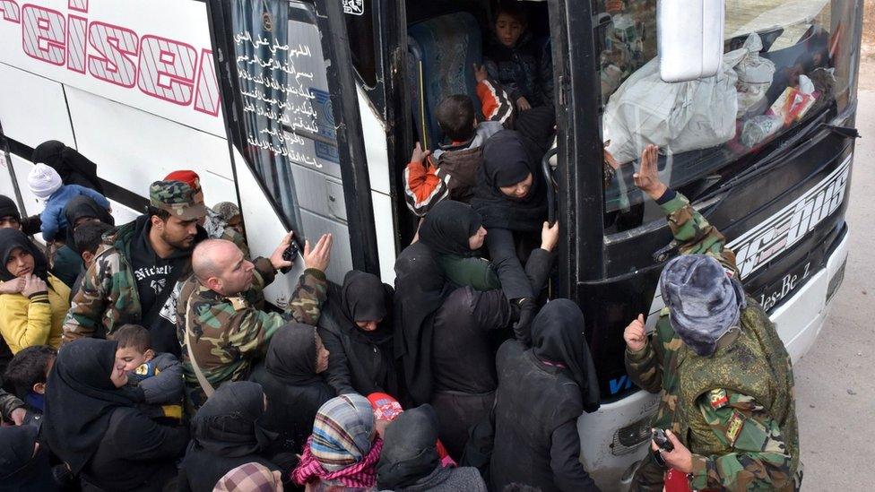 Displaced Syrian families queue to board government buses in the government-held eastern district of Jabal Badro, Aleppo (29 November 2016)