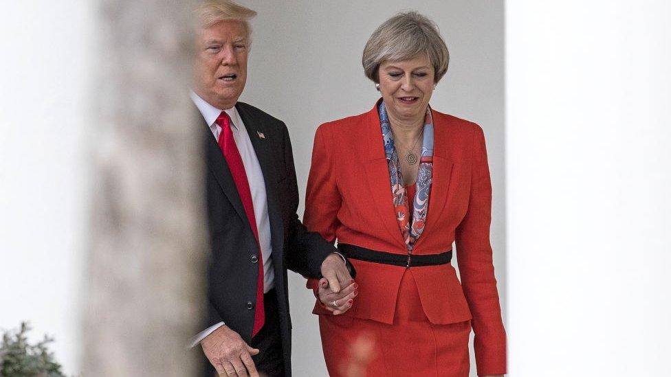 Former British Prime Minister Theresa May and Former President Donald Trump walk along The Colonnade of the West Wing at The White House on January 27, 2017