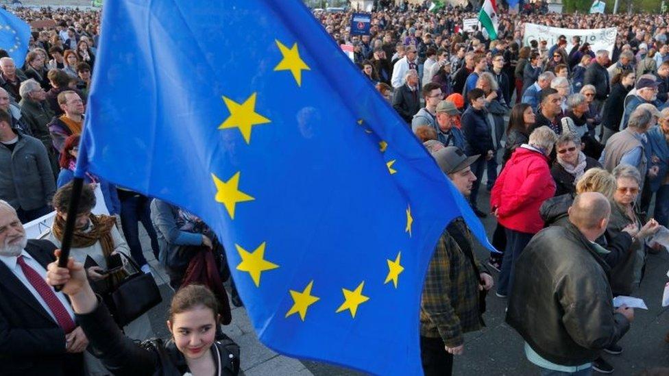 A woman holds a European Union flag during a protest in Heroes square against a new law that would undermine Central European University, in Budapest, Hungary on 12 April 2017.