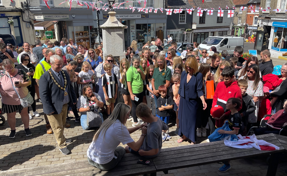 Lauren Hemp in front of crowds welcoming her home in North Walsham