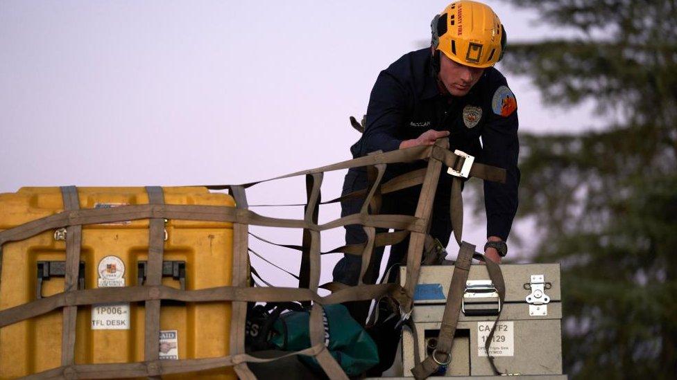 A US firefighter secures supplies for Turkey