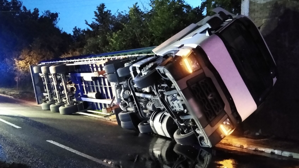 A lorry on its side on the A5