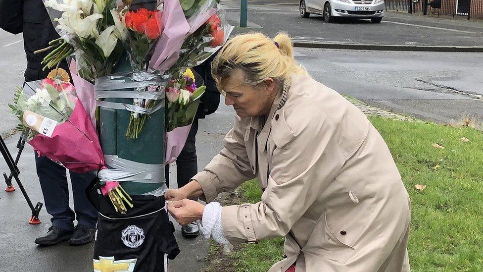 Woman ties shirt to lamppost