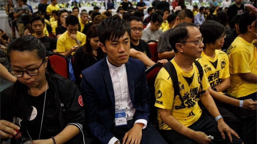 Civic Passion's Cheng Chung-tai (centre L) sits with supporters following his win in the Legislative Council election, at the central counting station in Hong Kong on September 5, 2016.