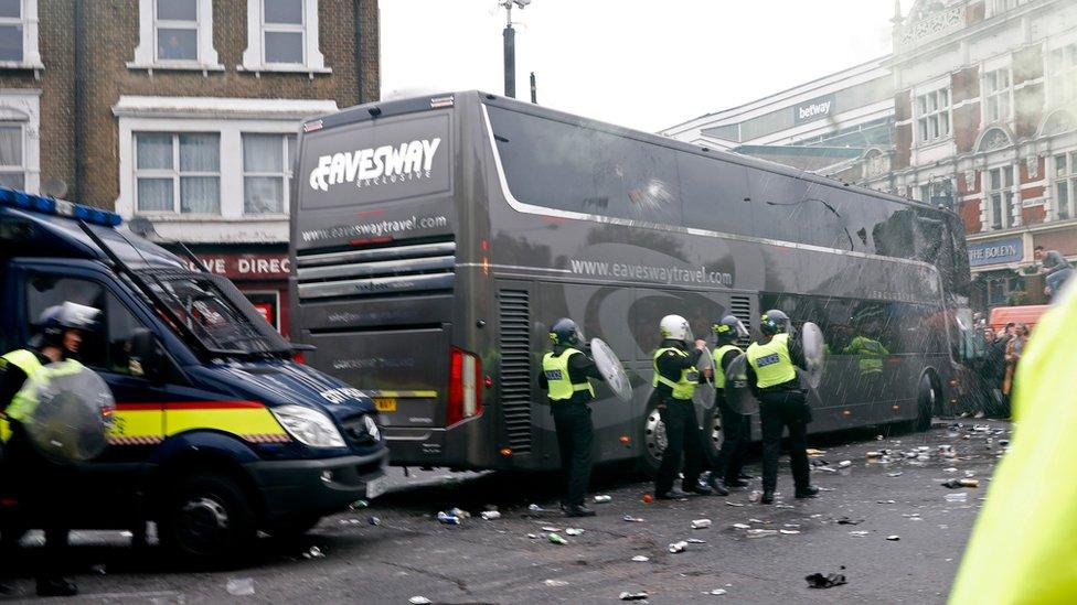 Bottles are thrown at the Manchester United team bus during clashes.