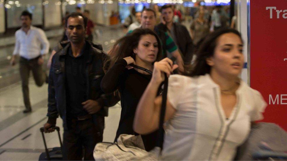 people running around a corner inside an airport, June 28 2016