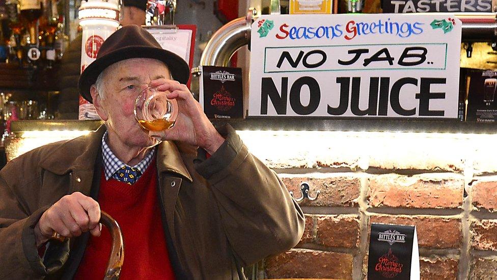 man having a drink in a bar